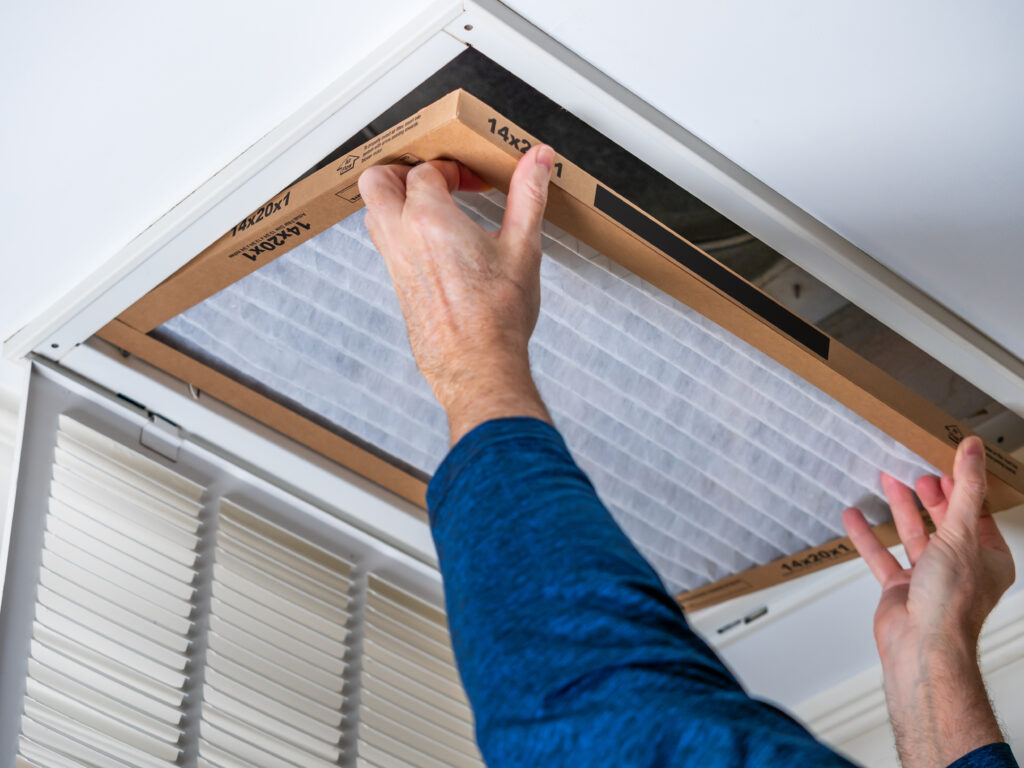 HVAC technician replacing a home air filter in Camarillo