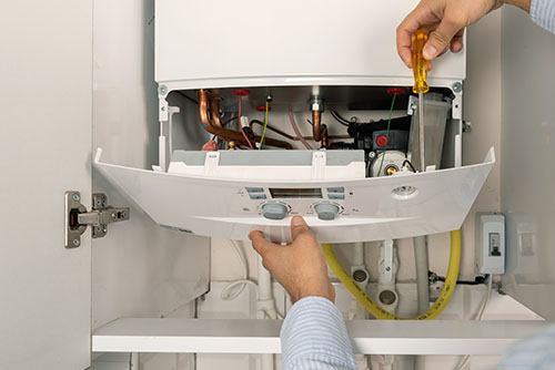 Heating technician repairing a residential boiler in Camarillo