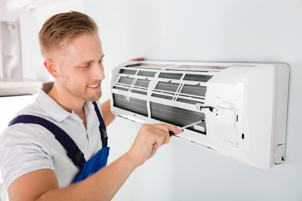 HVAC technician maintaining a ductless air conditioner in Camarillo