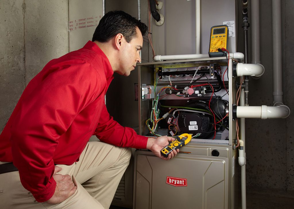 Heating technician diagnosing a furnace repair in Camarillo
