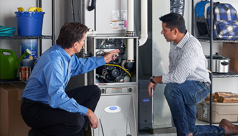 Technician evaluating a furnace for repair or replacement in Camarillo