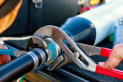 Technician repairing an industrial pipe connection in Camarillo