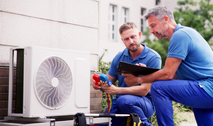 HVAC technicians installing an outdoor air conditioning unit in Camarillo