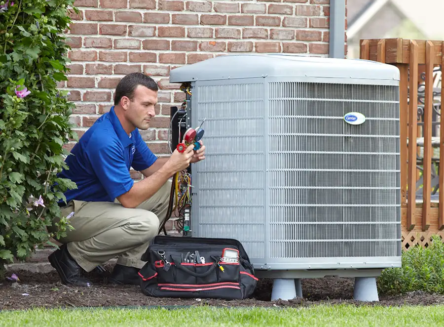 HVAC technician inspecting an outdoor AC unit in Camarillo