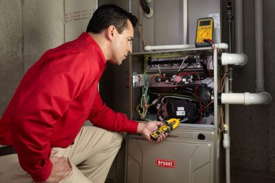 Heating technician diagnosing a furnace repair in Camarillo