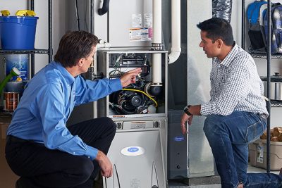 Technician evaluating a furnace for repair or replacement in Camarillo